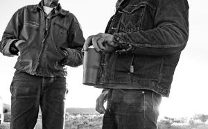 two men holding tumblers